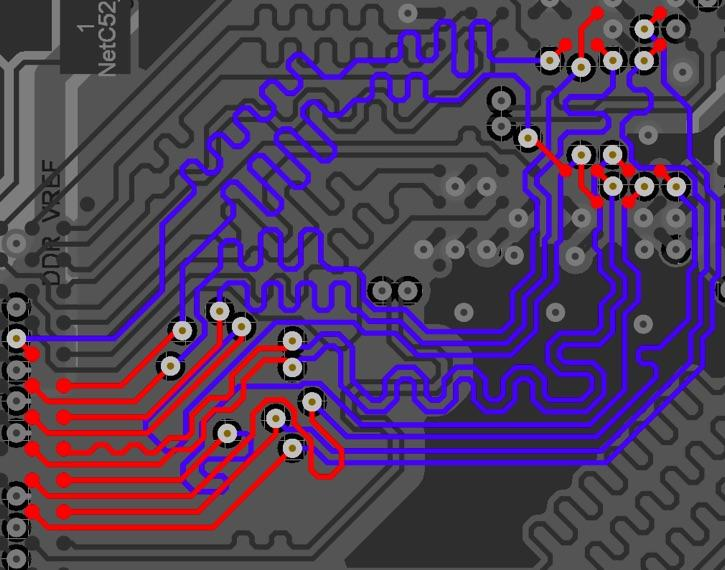 Color-coded PCB layout with tracks, connections, and labeled nets. Components represented by white dots.