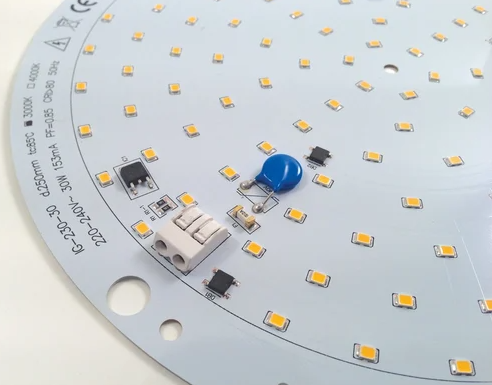 LED circuit board with yellow lights and blue button.
